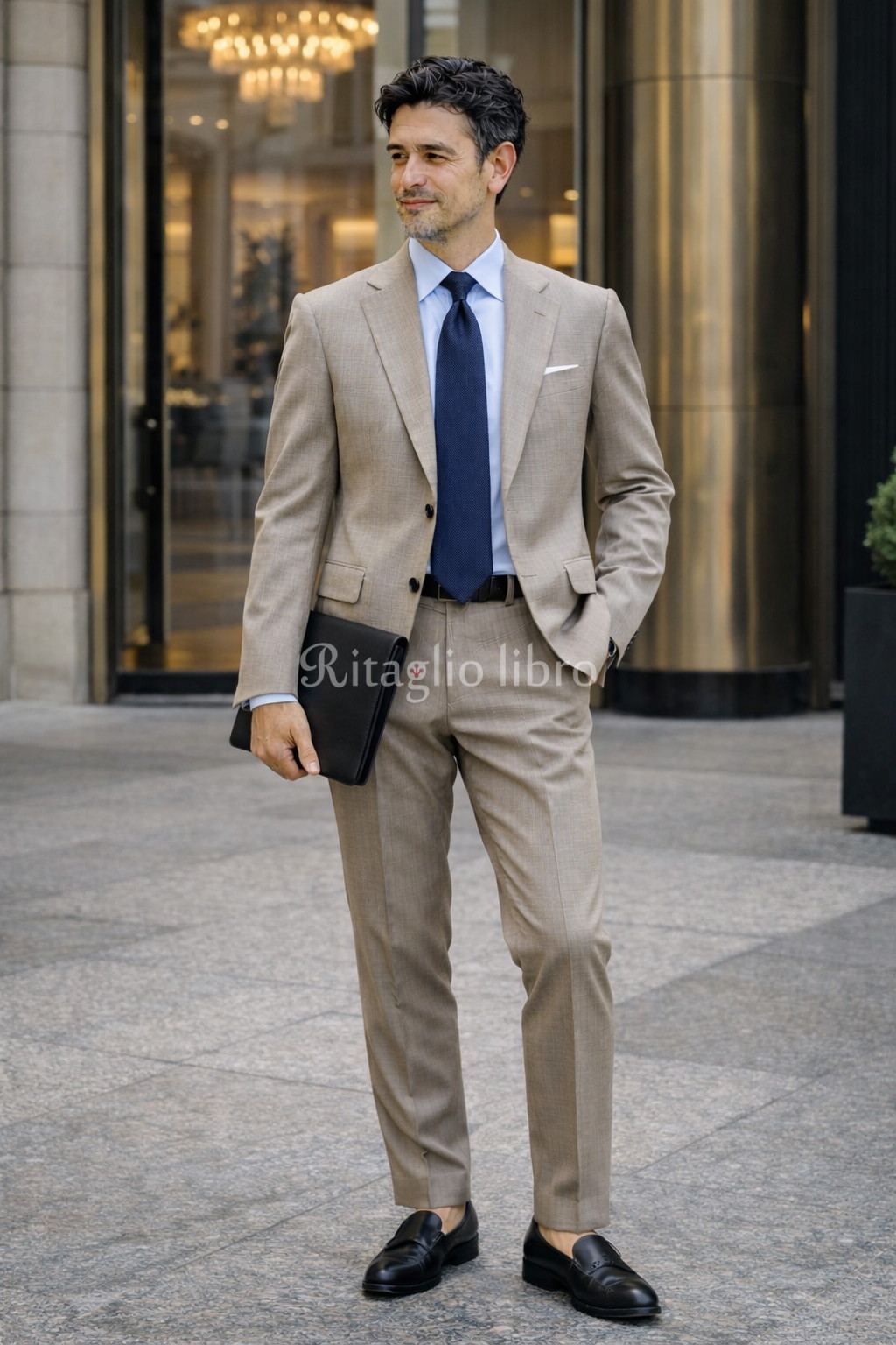 ベージュチェックスーツ × ブルータイ × クラッチ コンセプト “都会的ミニマル” コーデ詳細 ベージュチェックスーツ サックスシャツ ネイビータイ ブラックローファー ブラッククラッチ 撮影地:ホテルエントランス